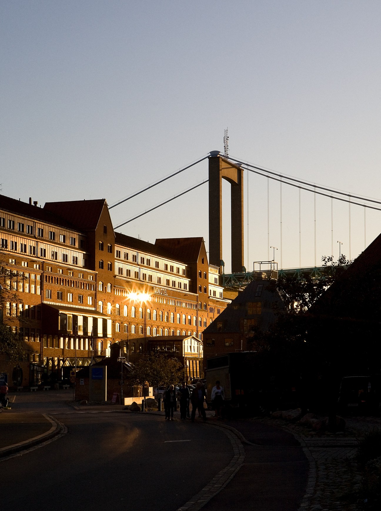 Gothenburg harbour with historic buildings and suspension bridge at dusk