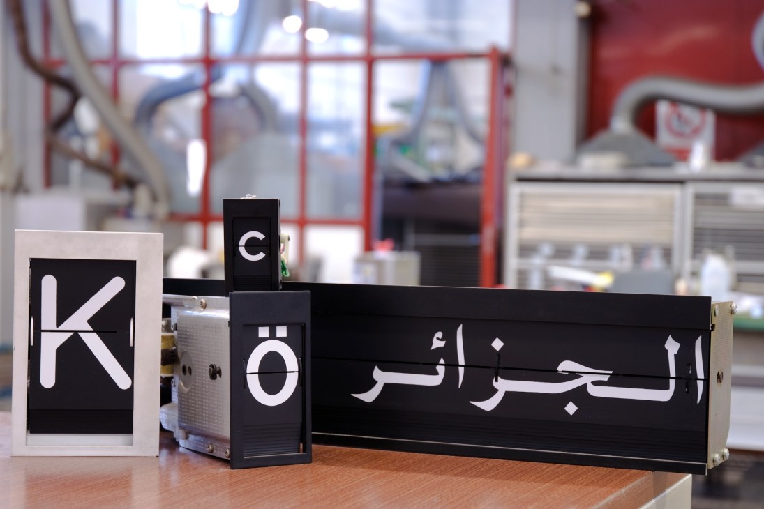 Silk-screened metal flaps displaying Roman and Arabic characters for Solari display boards.