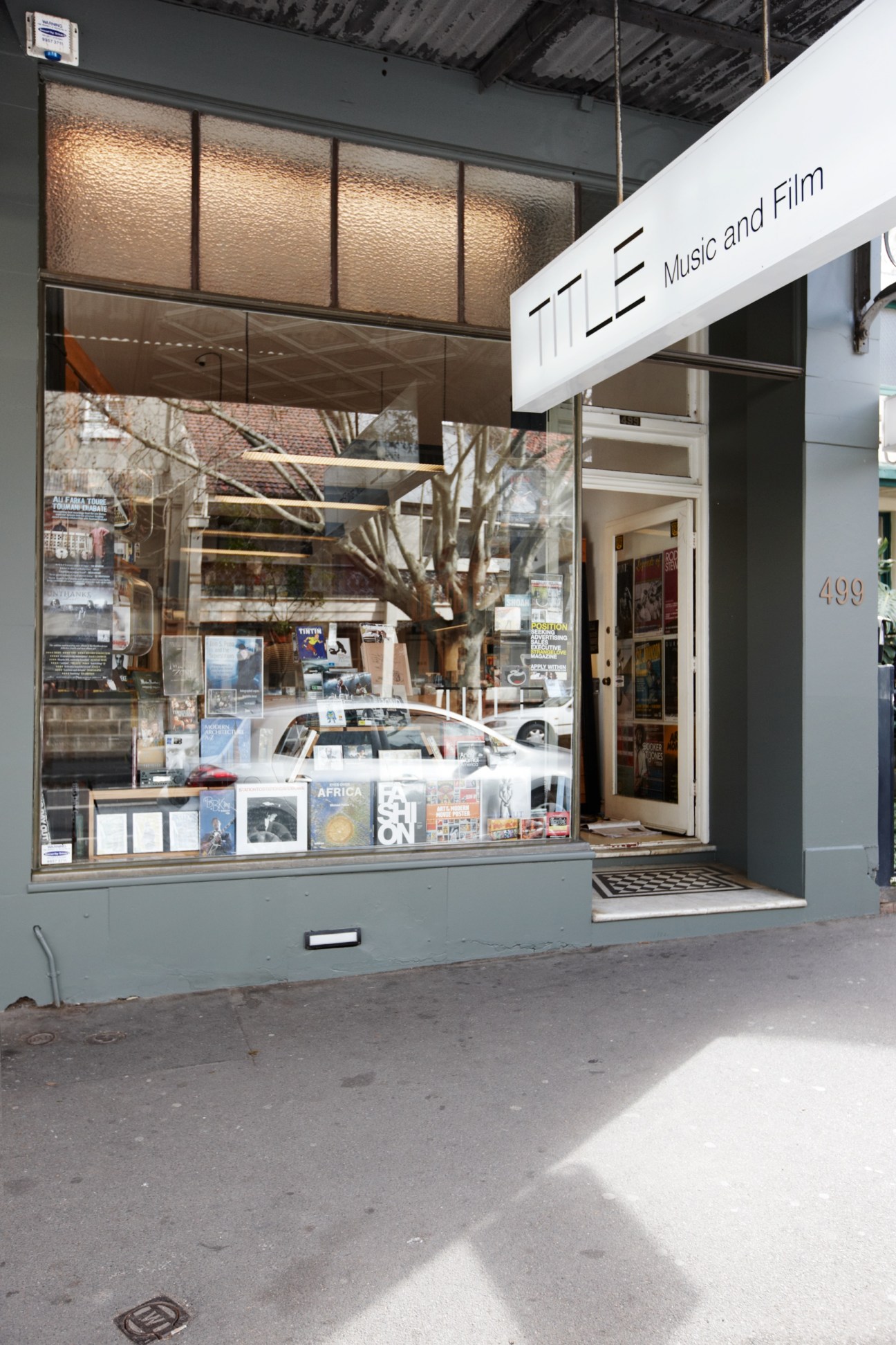 TITLE Music and Film storefront in Surry Hills, Sydney, displaying vinyl records, books, and DVDs in window.