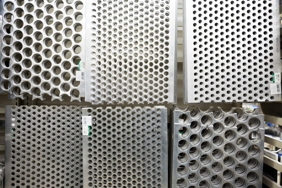 Display of stainless steel sheets and perforated metal panels with various hole patterns.