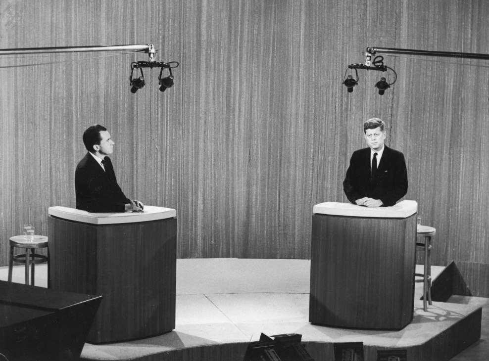 Black and white photograph of the 1960 televised presidential debate between Richard Nixon and JFK at separate podiums.