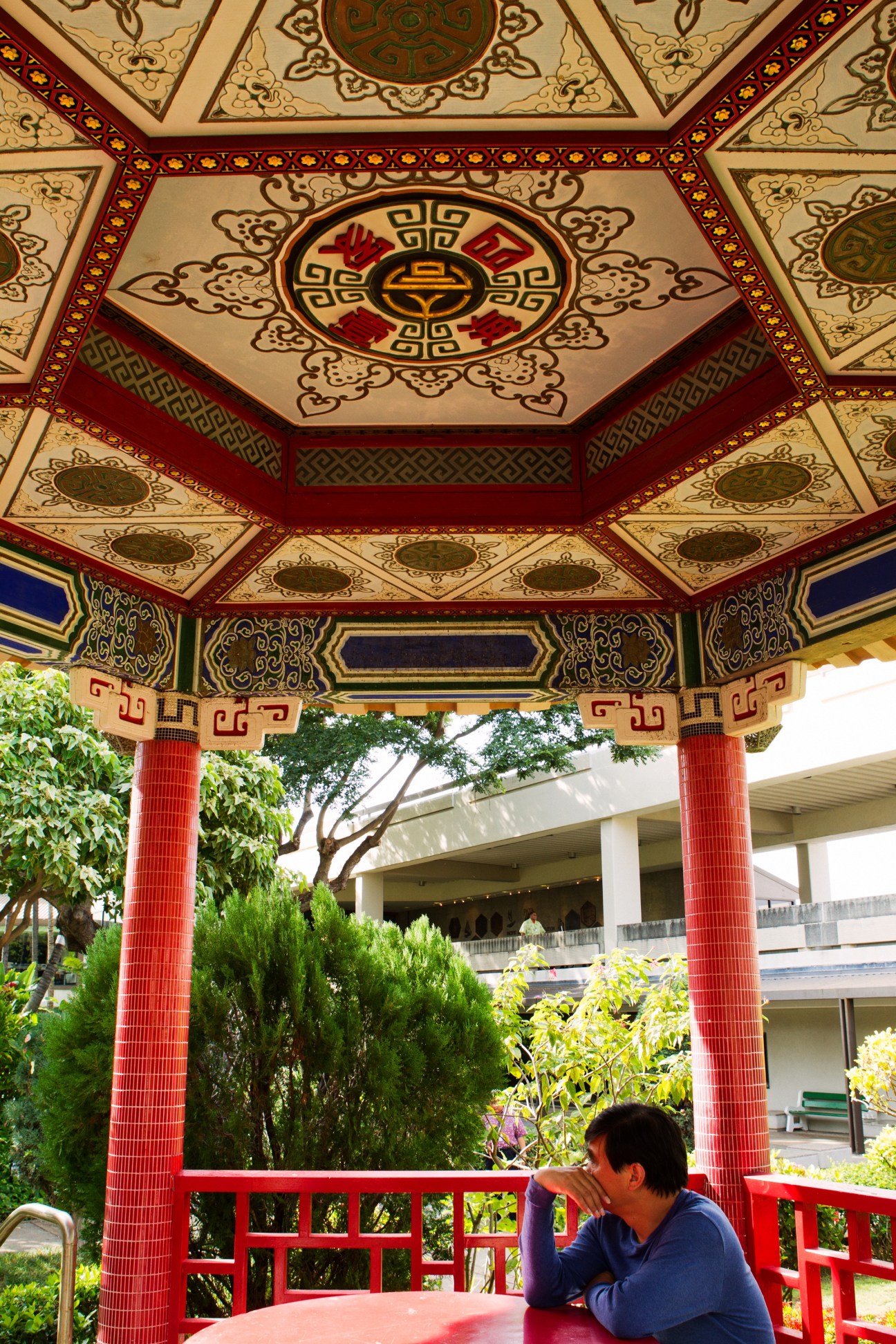 Ornate red and gold Chinese pavilion ceiling with decorative geometric patterns and central medallion.