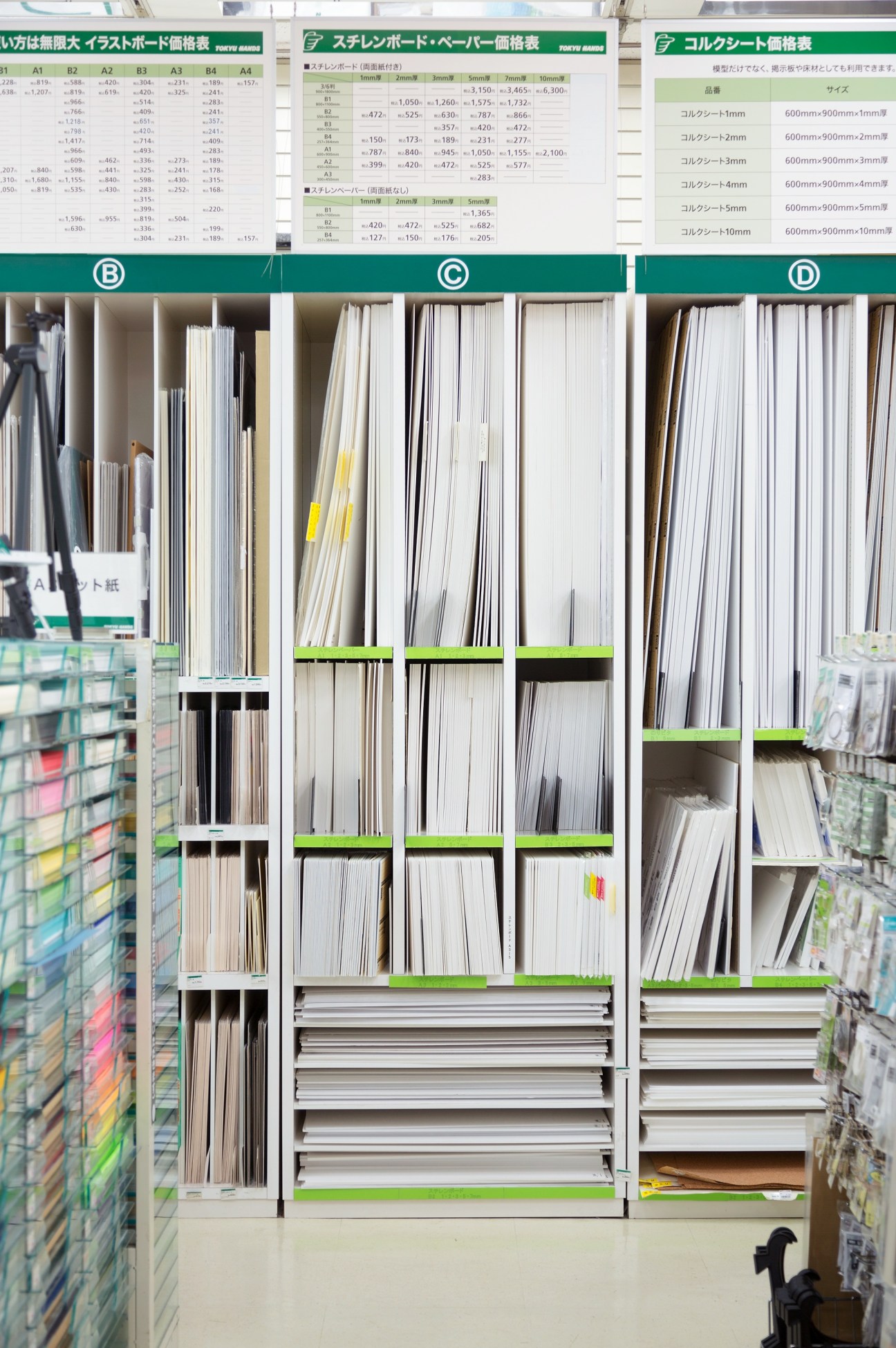 Shelving units displaying stacked polystyrene boards and sheets in various thicknesses, organized by size categories marked B, C, and D.