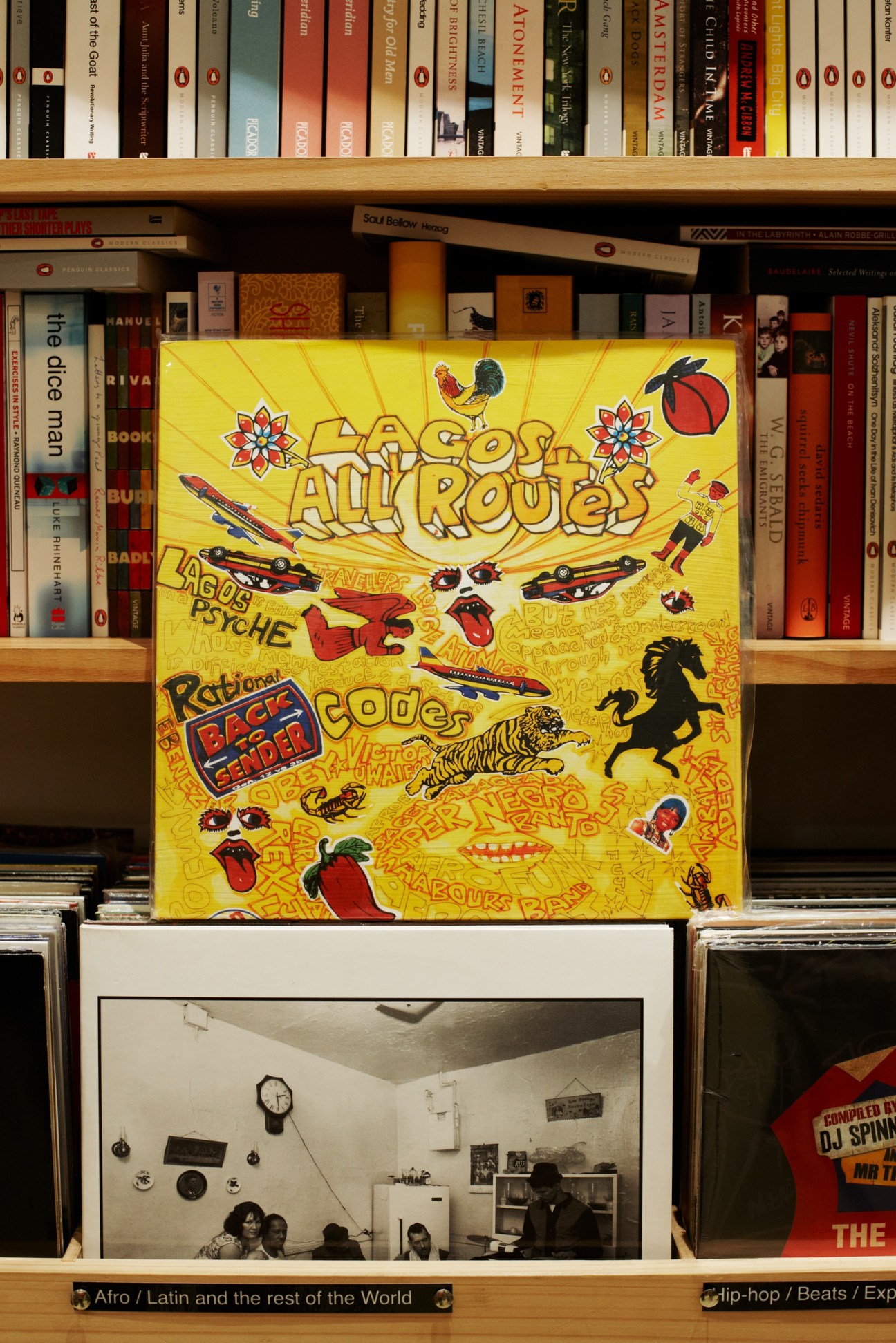 Vinyl records and books displayed on wooden shelves at TITLE music store in Sydney.