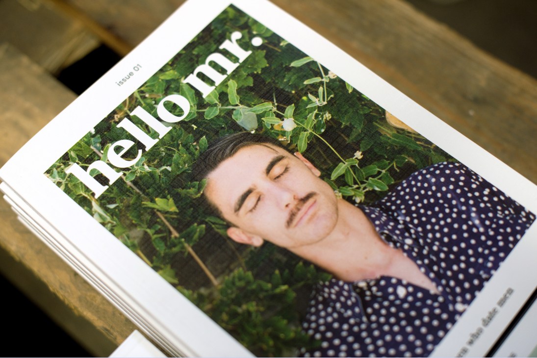 First issue of Hello Mr magazine displayed on wooden surface, featuring portrait cover.
