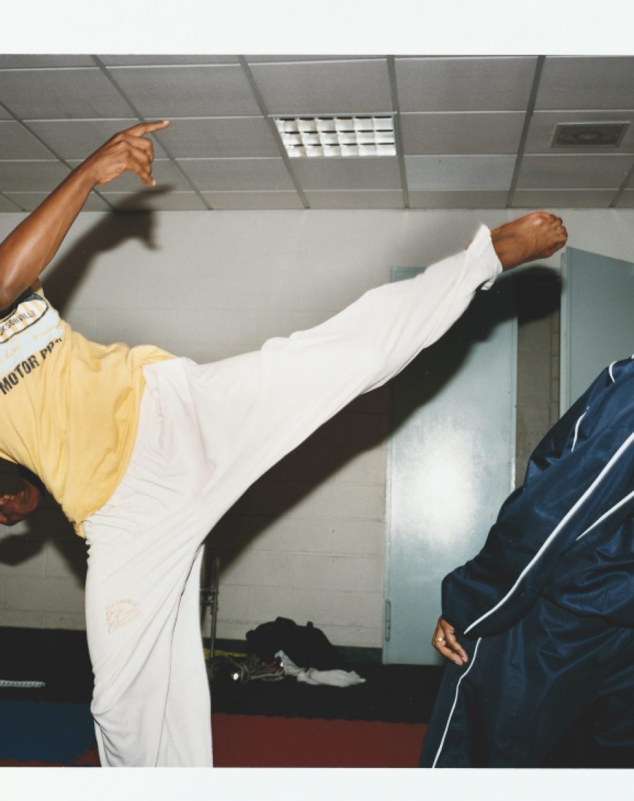 Cape Verde's taekwondo team practice in a tiled room with one athlete performing a high kick.