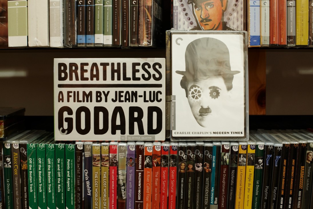 DVD shelf displaying classic films in quality Criterion Collection editions including Breathless and Modern Times.