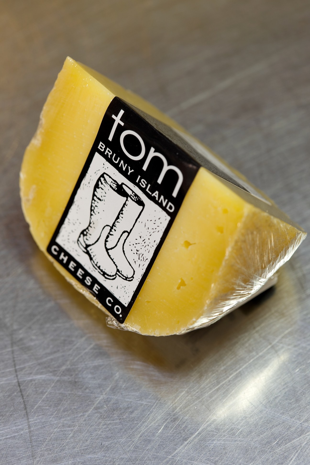 Tom cheese from Bruny Island Cheese Co with black and white label featuring boot illustrations.