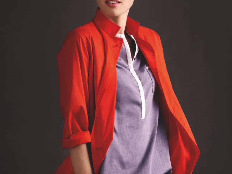 Model wearing Hermès red jacket, Closed shirt, Innamorato trousers, Polo Ralph Lauren glasses and Roarke NYC bracelet