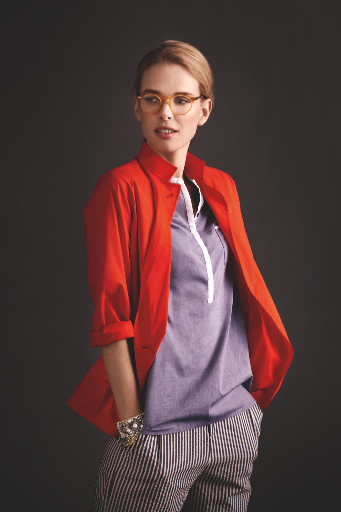 Model wearing Hermès red jacket, Closed shirt, Innamorato trousers, Polo Ralph Lauren glasses and Roarke NYC bracelet