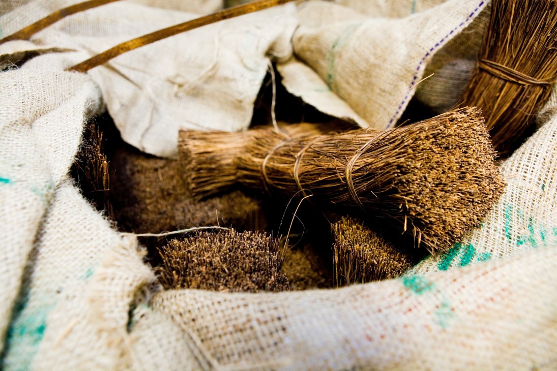 Various brush bristles and materials stored in cloth wrapping at Iris Hantverk workshop.