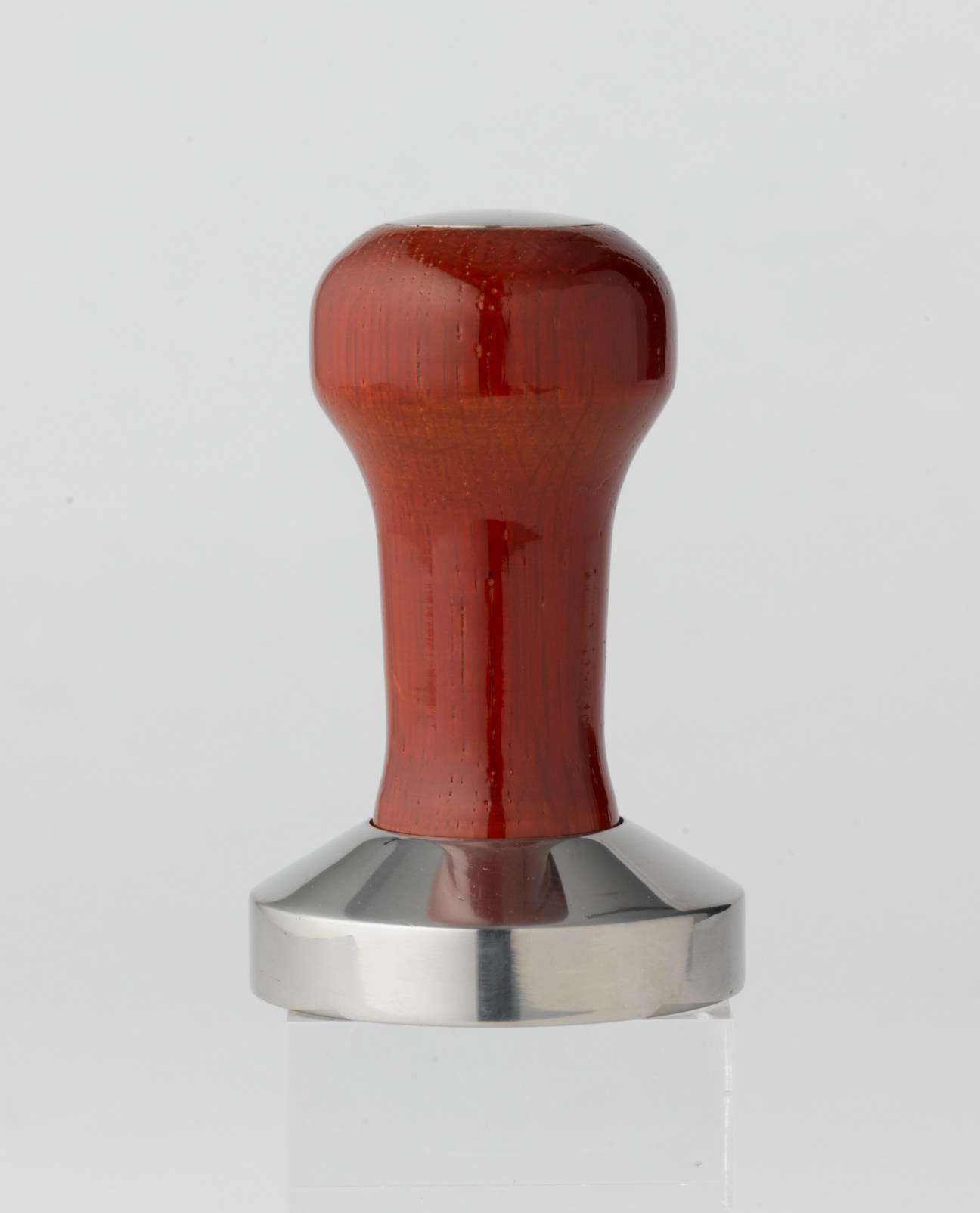 Red wooden-handled Ascaso coffee tamper with stainless steel base.