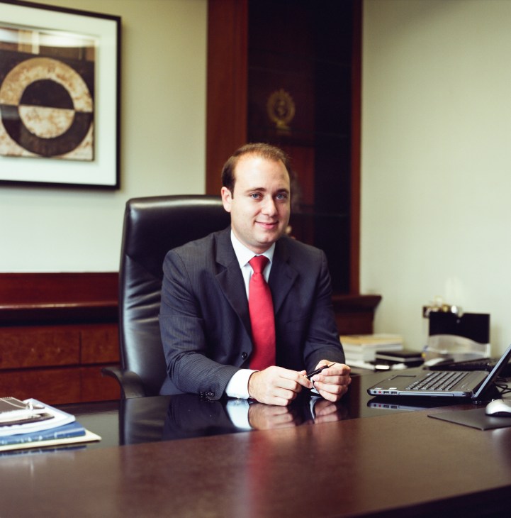 Daniel Manucci, a lawyer, sits at his desk in a professional office setting.