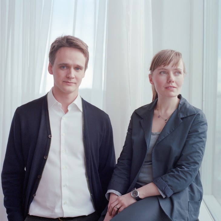 Baldur Mar and Svanhildur Sigurðardóttir stand together in professional attire against a white curtained background.