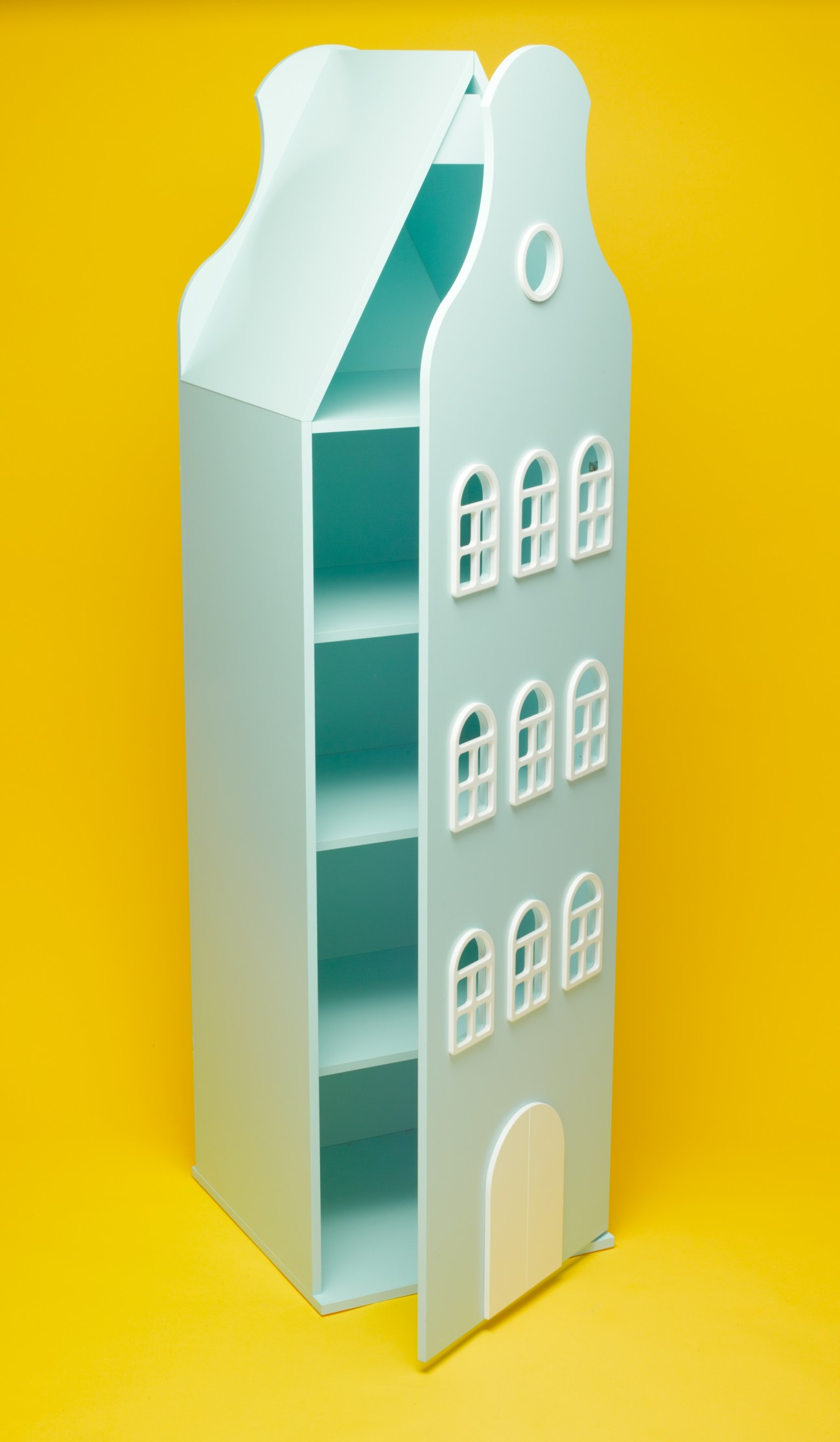 Turquoise and white children's cabinet inspired by Amsterdam architecture with multiple shelves and windows against yellow background.
