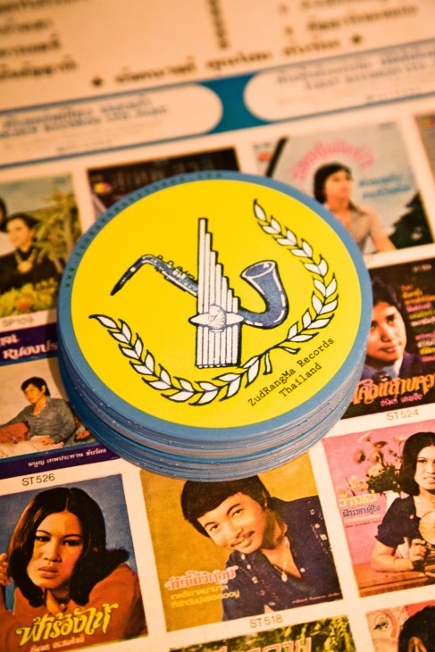 Yellow vinyl record label for Zudrangma Records Thailand with blue border, displayed on Thai music albums.