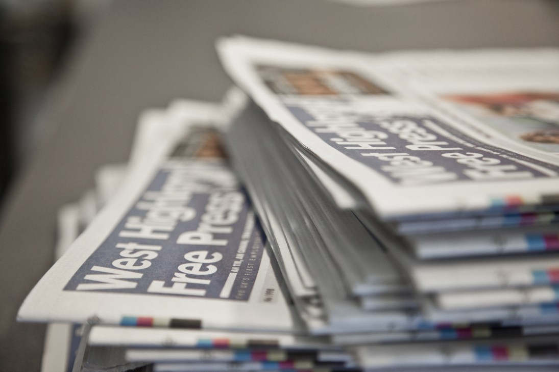 Stacked copies of West Highland Free Press newspapers with visible masthead on front page.