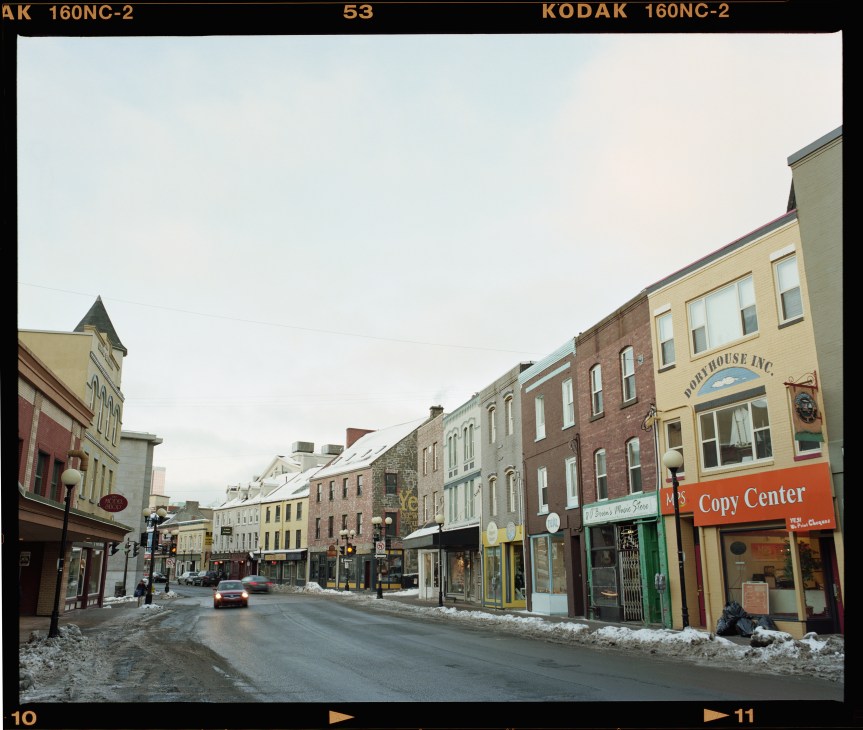 Water Street in St John's lined with colourful historic buildings featuring shops and businesses.