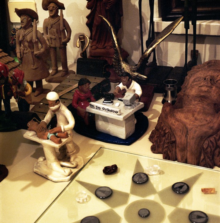 Collection of decorative sculptures and artifacts displayed in Dr. Ivo Pitanguy's clinic trophy room.
