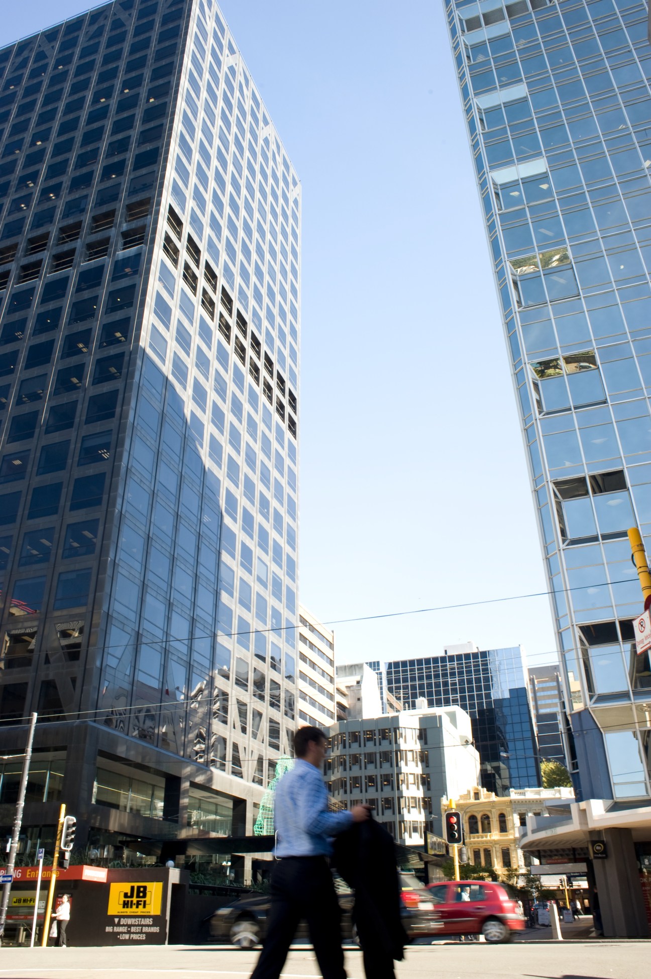 Tall office buildings in Wellington's Central Business District with pedestrians crossing the street.