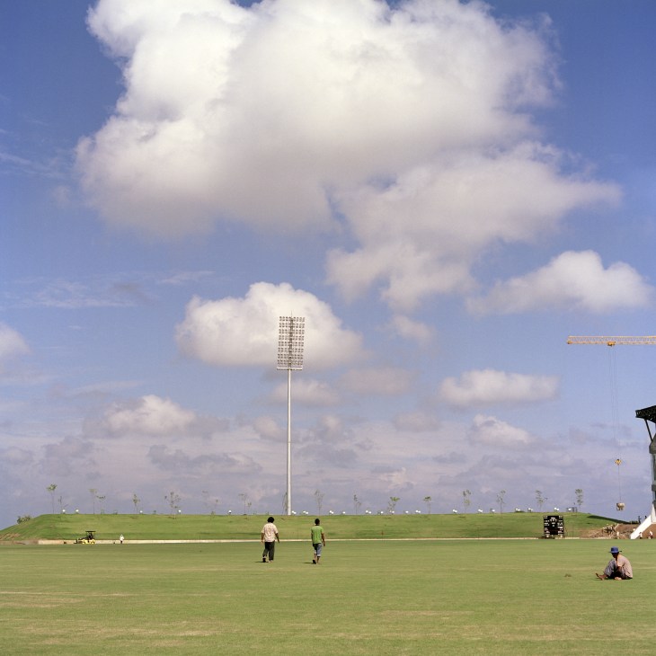 The Suriyawewa International Cricket Stadium under construction in Hambantota with tall floodlights and green field.
