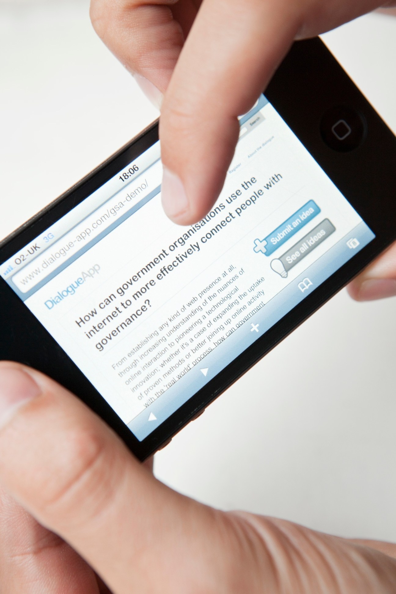 Hand holding smartphone displaying Dialogue app interface about government organization and internet governance.