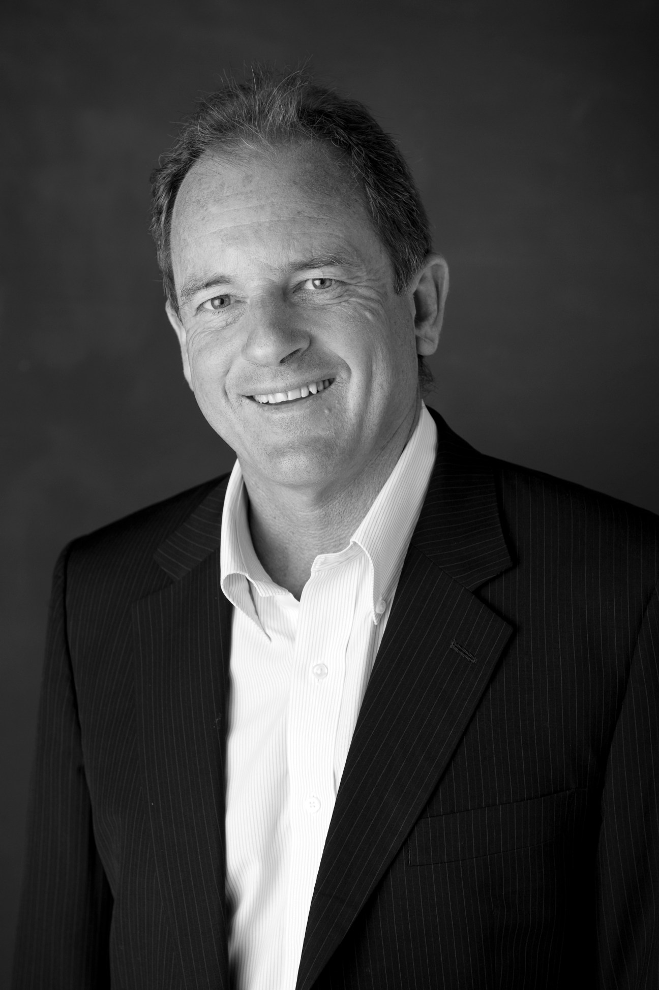 Black and white portrait of David Shearer, Leader of the Opposition in New Zealand, smiling at the camera.