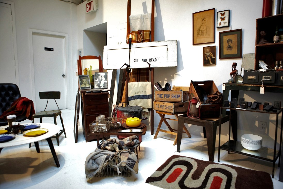 Interior of Pop Up Flea vintage shop displaying curated furniture, artwork, textiles and home goods.