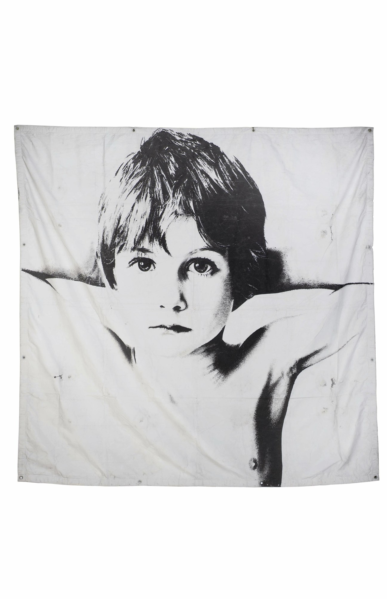 Black and white portrait print of a woman with short dark hair and bangs against a white fabric backdrop.