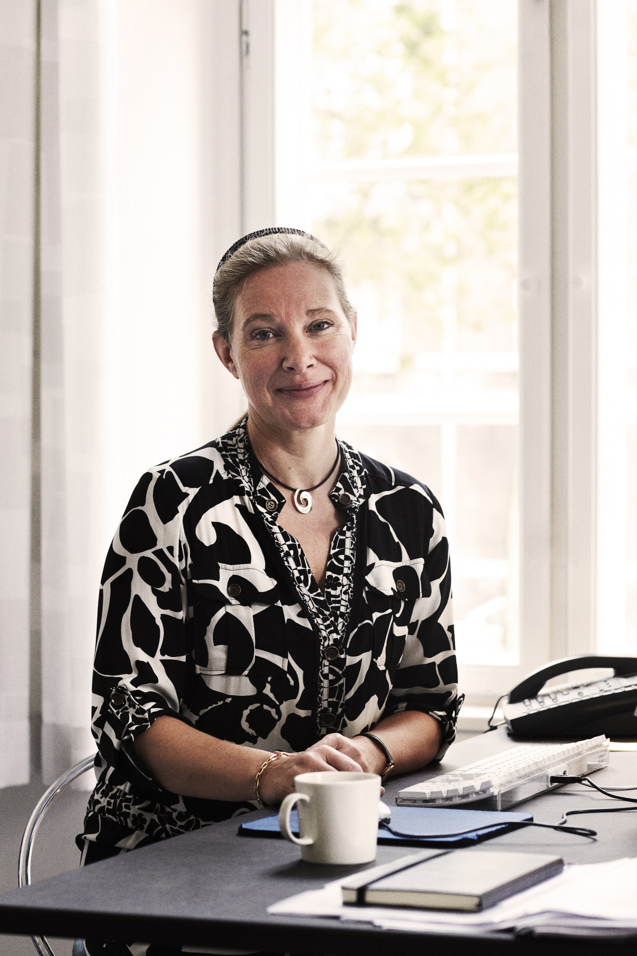 Anne-Louise Sommer, rector of the Danish Design School, seated at her desk.