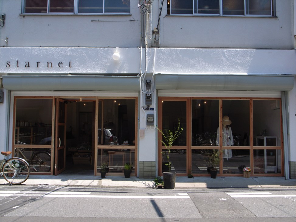 Starnet shop storefront in Osaka with wooden-framed glass doors and white signage above.