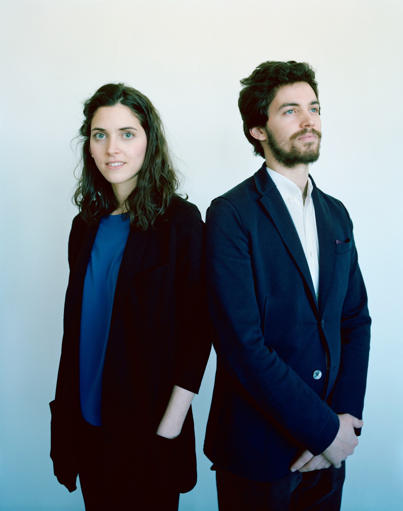 Portrait of Giulia Acchiardi and her brother Aldo standing against a white background.