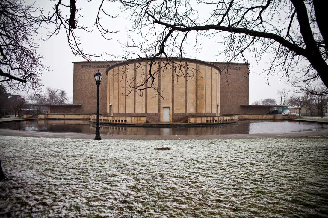 Kleinhaus Music Hall by Eero Saarinen, a modernist brick building with curved glass facade reflected in surrounding water.