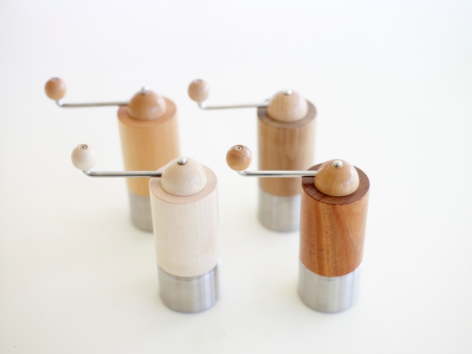 Patrick Senior's wooden coffee grinders with metal components and various wood finishes.