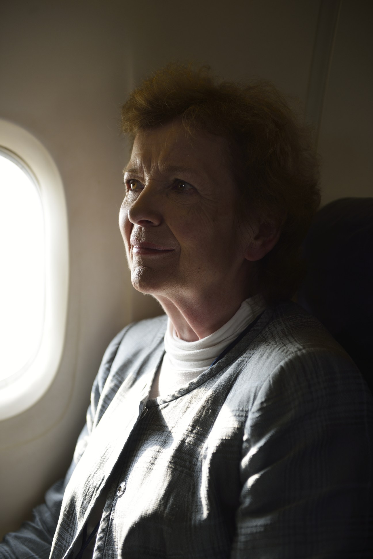 Former Irish president Mary Robinson gazes out an airplane window during flight to Juba.