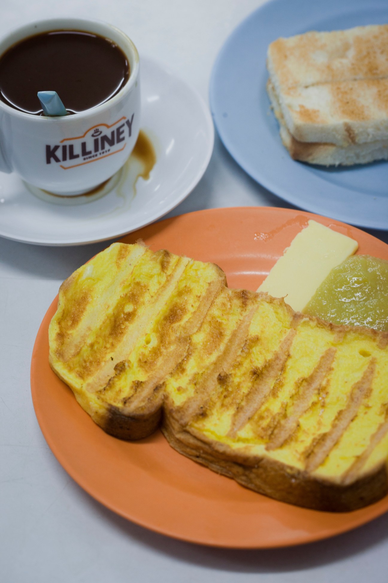 French toast with kaya spread and butter from Killiney Kopitiam, served with coffee in branded cup.