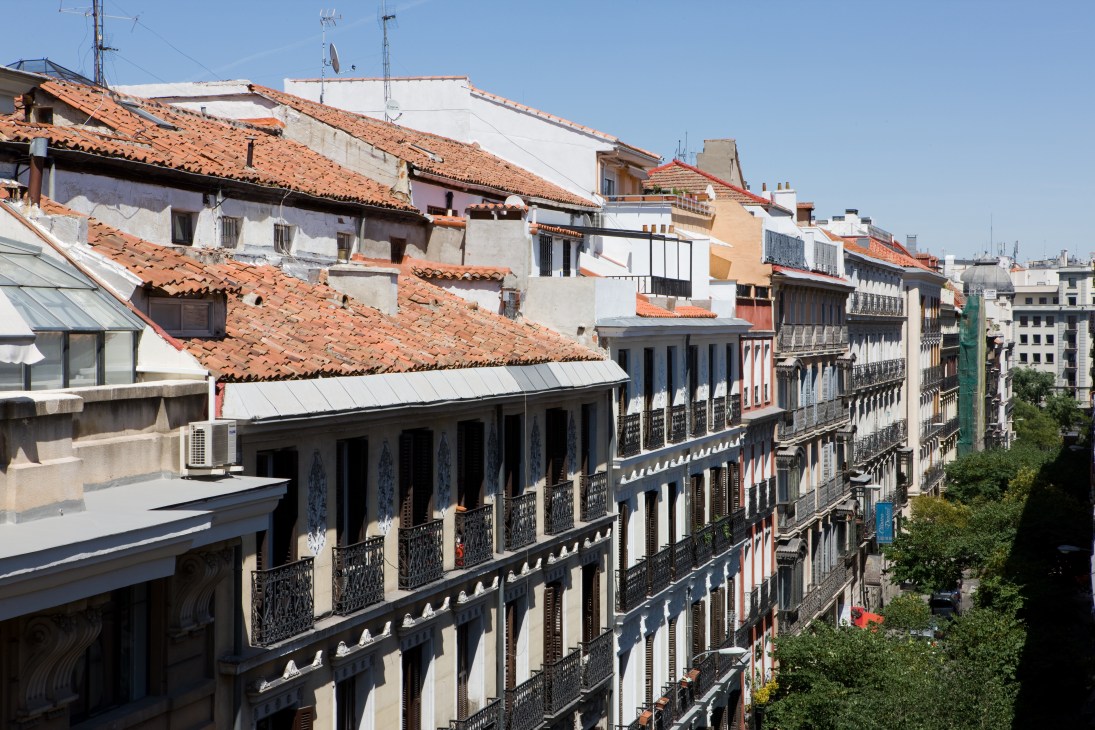 Madrid rooftops with Bourbon-era balconied buildings overlooking the Chueca neighbourhood.