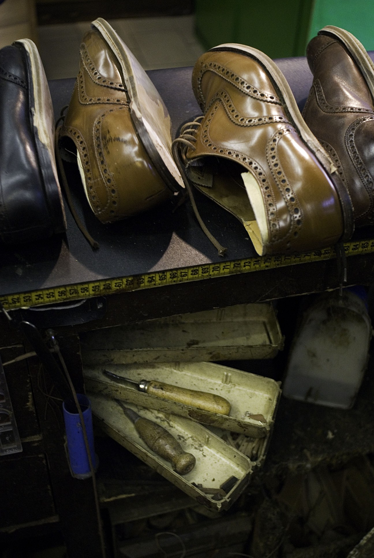 Brogues with new soles being fitted at Ermanno Alvisi's shoe repair shop in Milan.