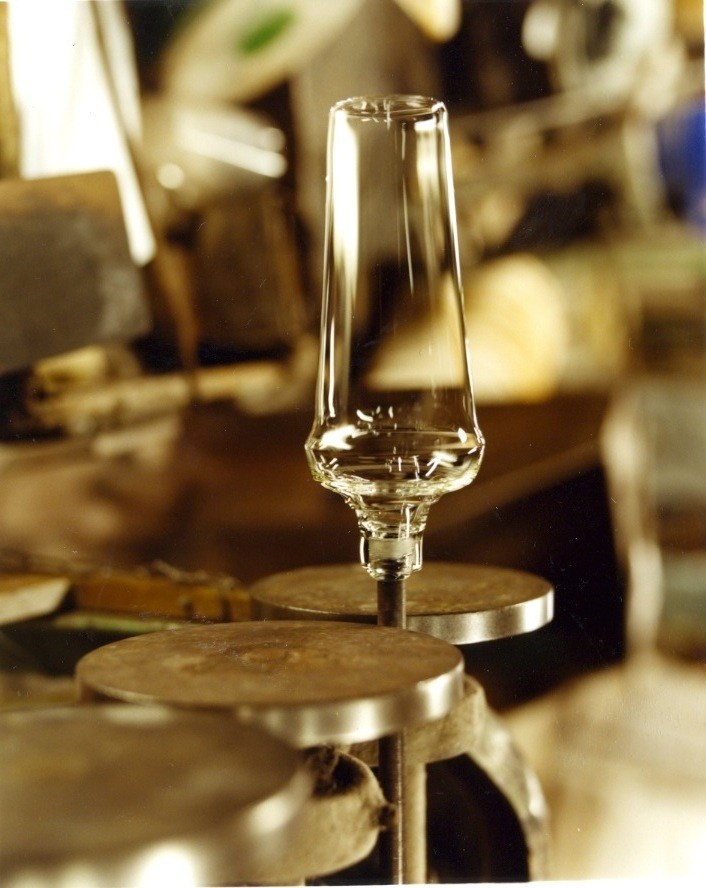 A translucent ultra-thin Usuhari glass displayed on a wooden mould in Shotoku's factory.