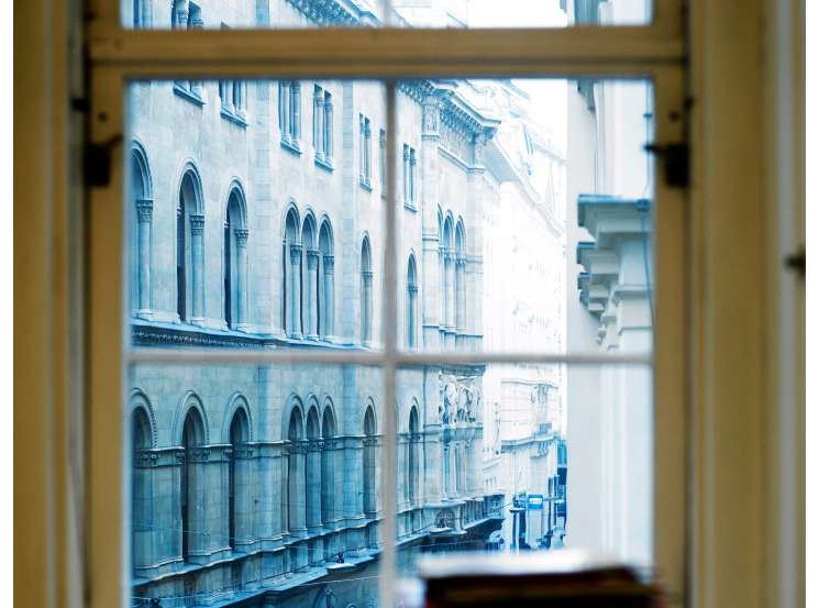 View through a window of classical Vienna architecture on Herrengasse street from an office.