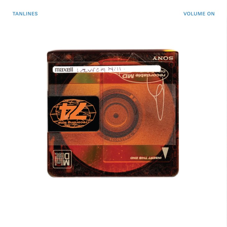 Tanlines' album cover 'Volume On' featuring an orange and red cassette tape design with geometric patterns.