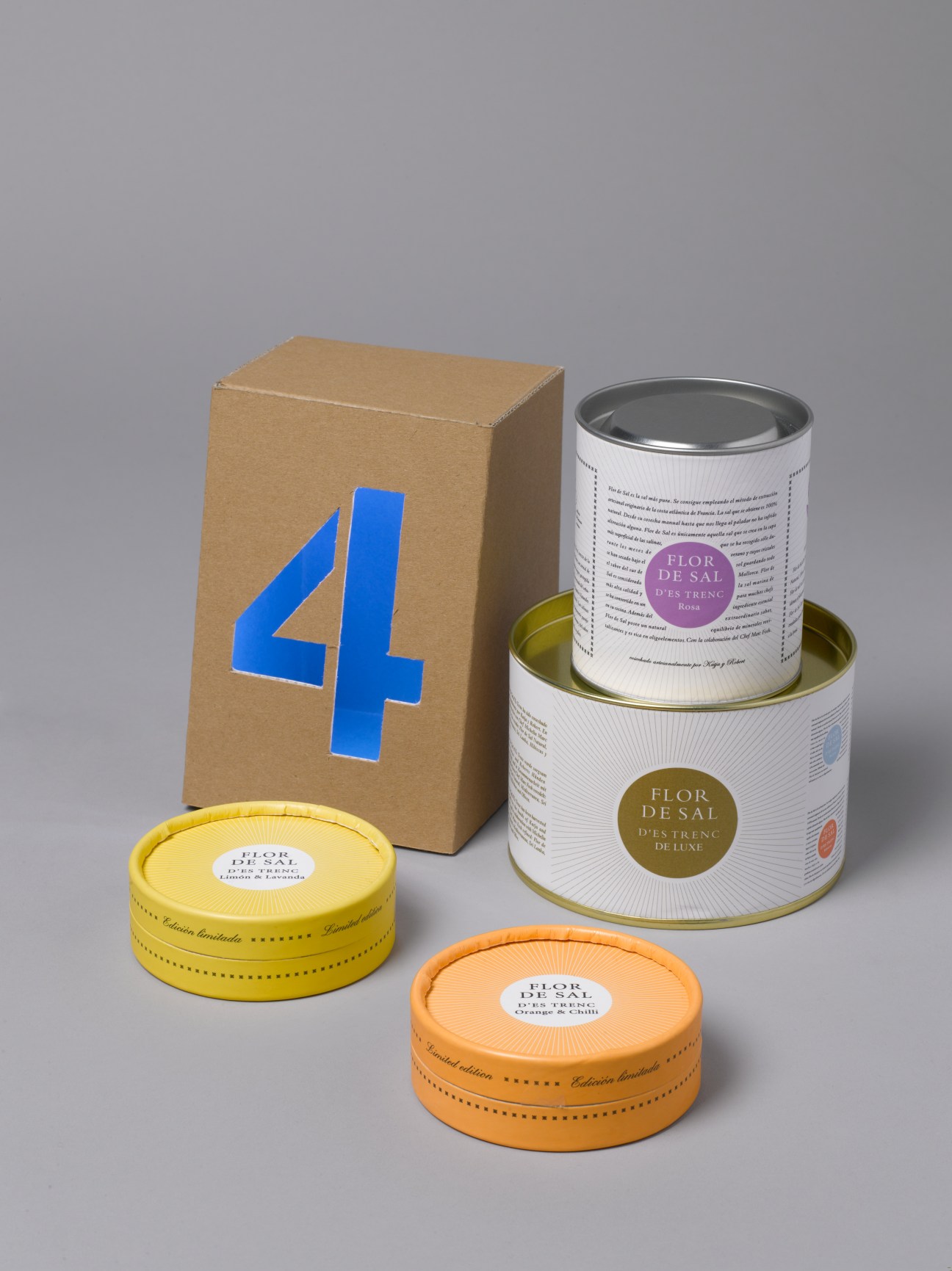 Flor de Sal premium sea salt products from Mallorca in branded cardboard box and tins with yellow and orange lids.