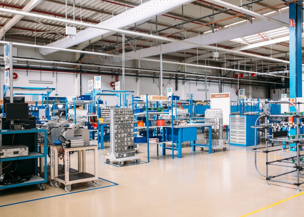UTC Aerospace Systems aeronautics manufacturing plant interior with blue workstations and industrial equipment in Nouaceur, Morocco.
