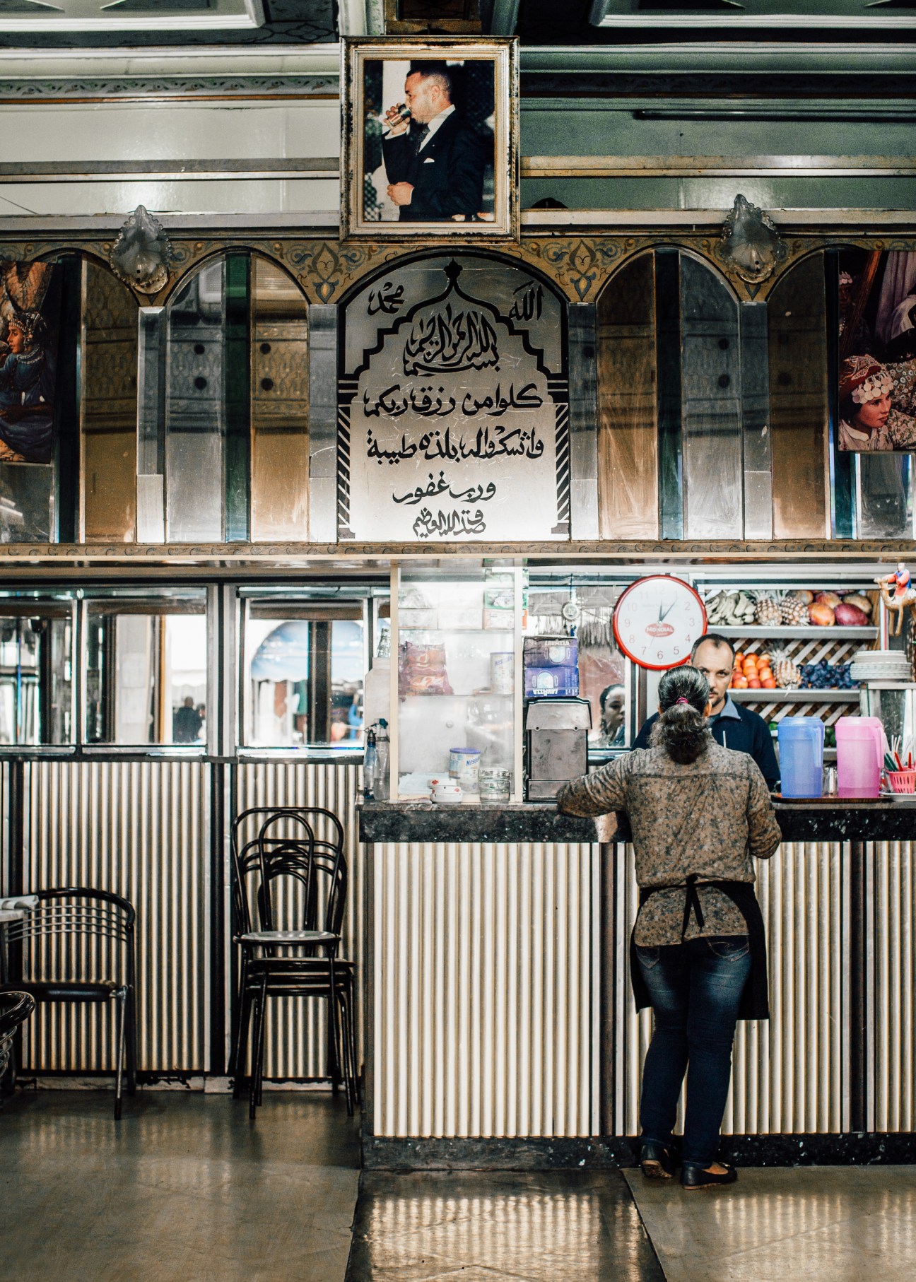 King Mohammed VI portrait displayed above a shop counter in a Casablanca café.