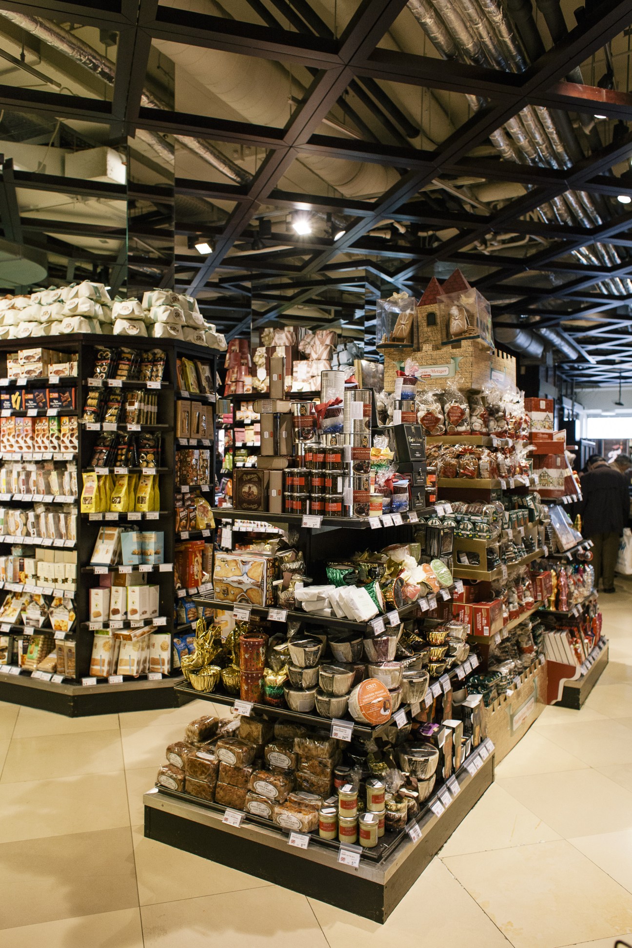 Interior of Julius Meinl gourmet shop displaying packaged goods and delicacies on shelves and central display stand