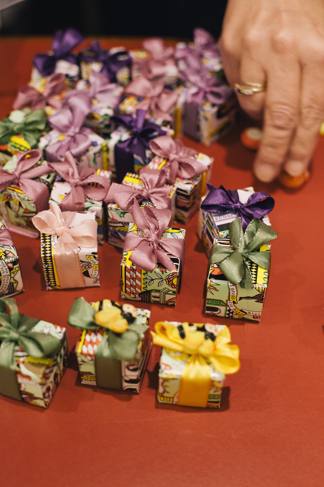Handmade chocolate bonbons in colorful boxes with ribbon bows at Altmann & Kühne confectionery.