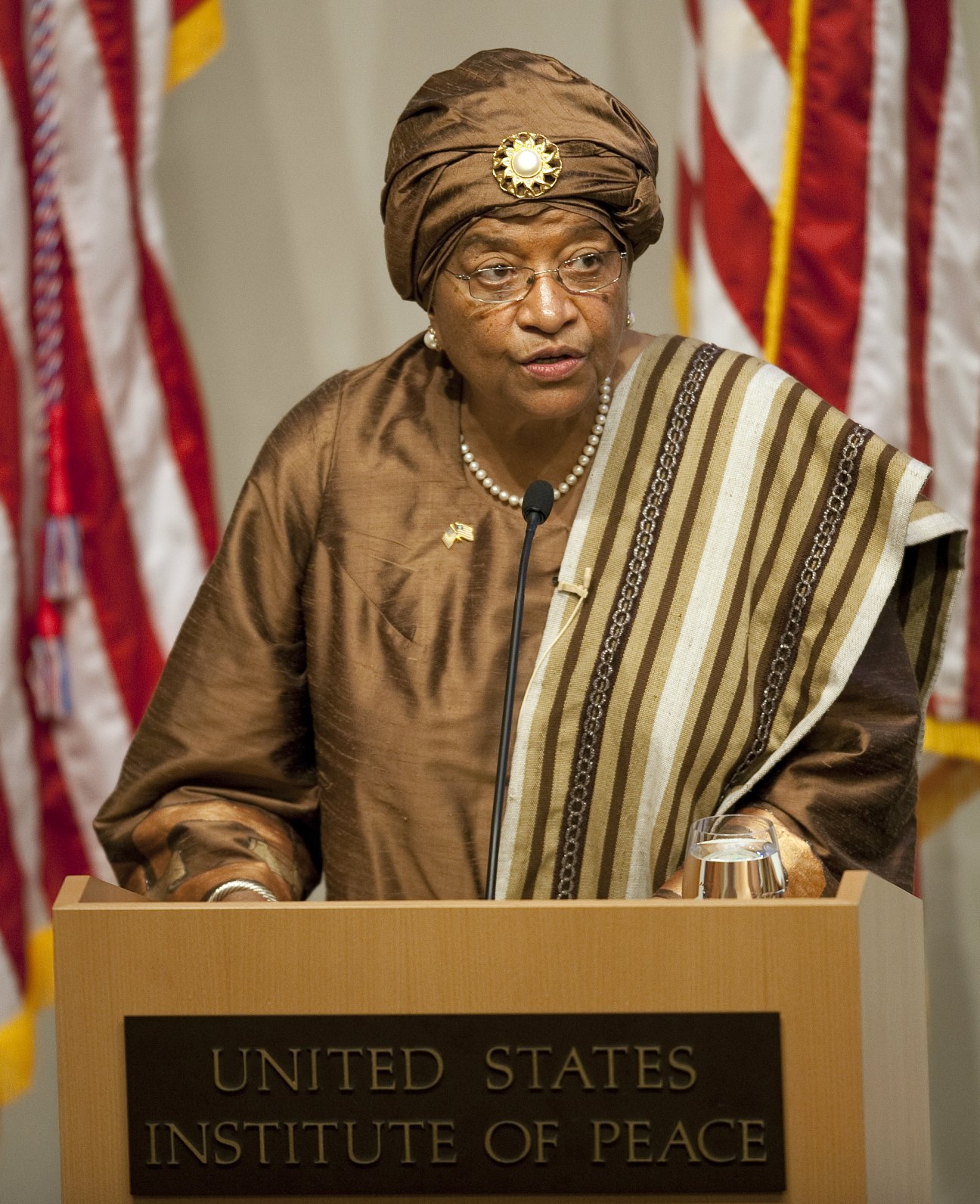 Ellen Johnson Sirleaf speaking at a podium at the United States Institute of Peace.
