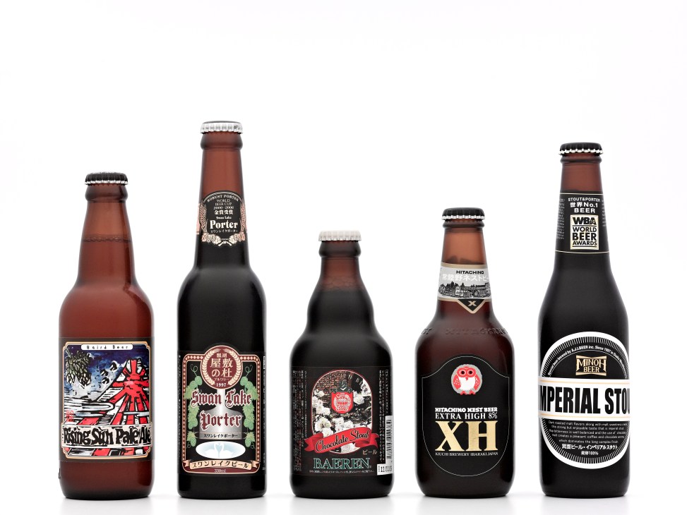 Five Japanese craft beer bottles displayed against a white background showing various porter, stout and pale ale labels.