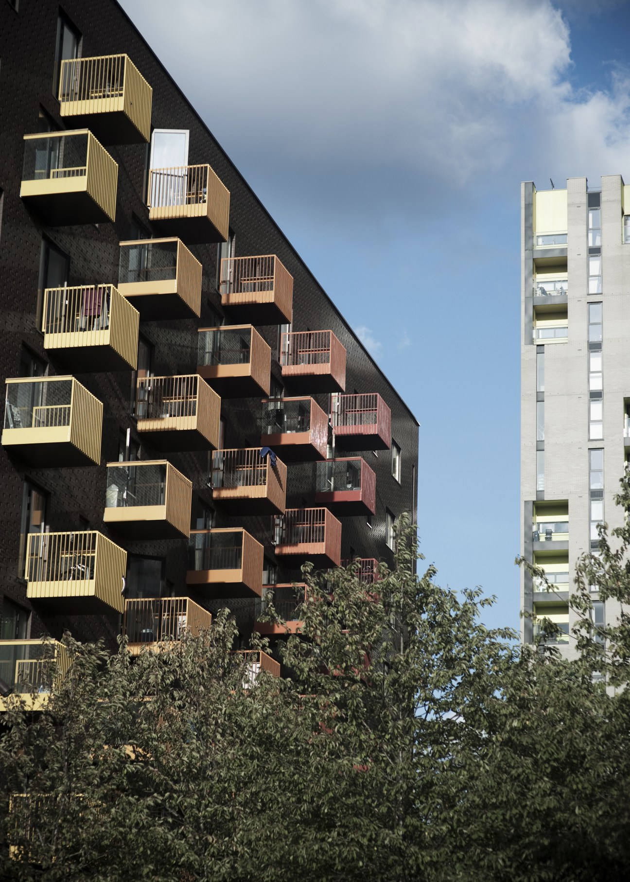 Modern residential building with colorful cantilevered balconies in Barking Town Square