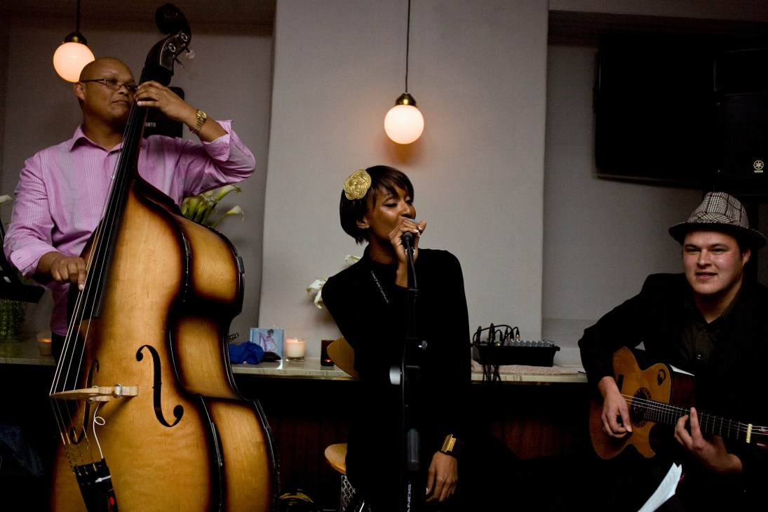 Live band performing at Brewers & Union with cellist, female vocalist, and guitarist on stage